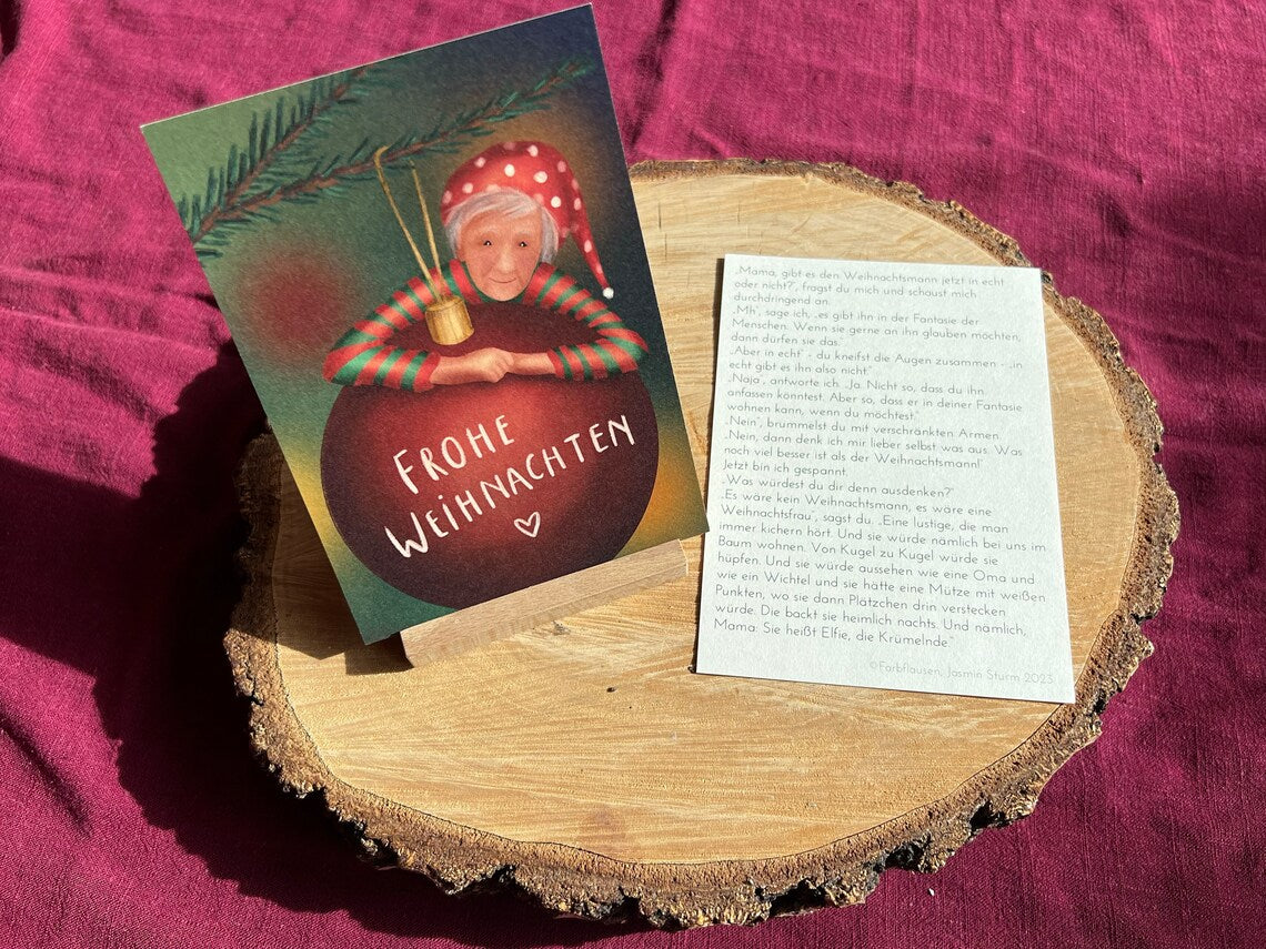 Postkarte "Elfie, die Krümelnde" | Eine besondere Weihnachtskarte mit einer Geschichte über eine lustige Weihnachtsfrau und wo sie wohnt.
